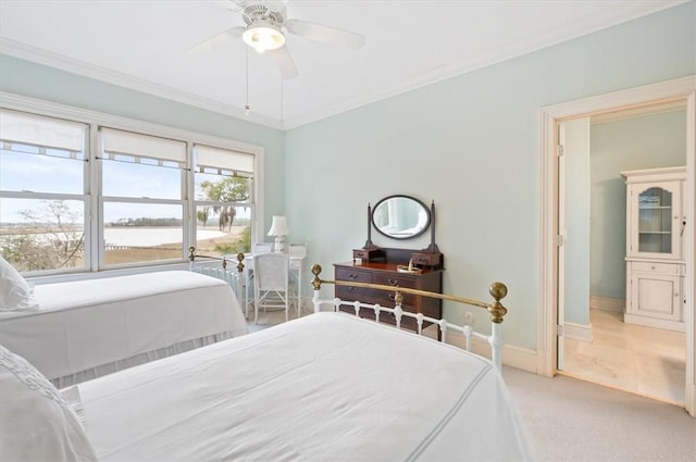 bedroom featuring light carpet, ceiling fan, baseboards, and ornamental molding