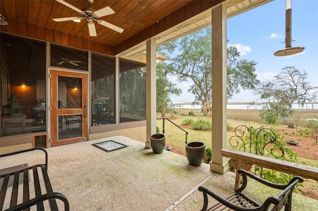 sunroom with a ceiling fan and wood ceiling