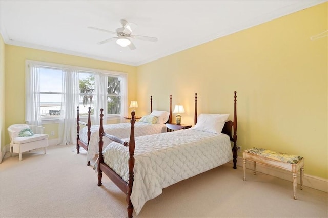 bedroom with a ceiling fan, crown molding, light colored carpet, and baseboards