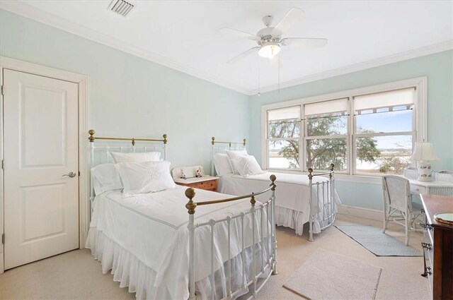 bedroom with crown molding, light colored carpet, visible vents, and ceiling fan