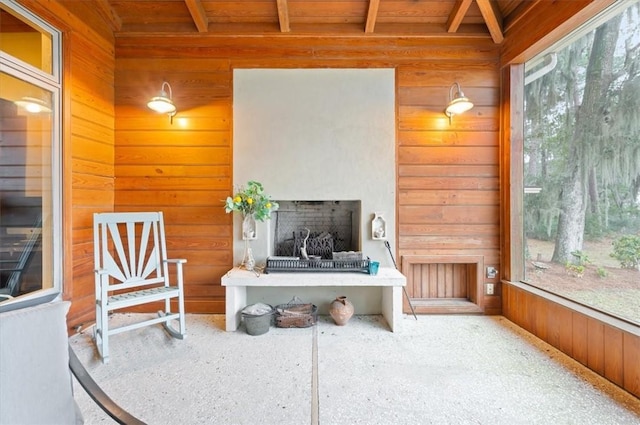 sunroom featuring beamed ceiling and wood ceiling