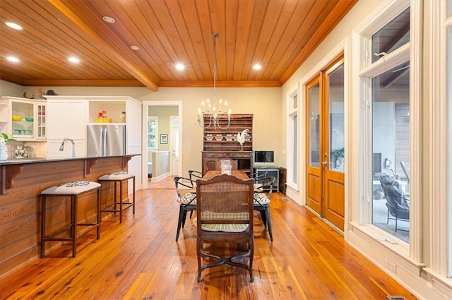 dining room featuring an inviting chandelier, recessed lighting, crown molding, light wood-type flooring, and wooden ceiling