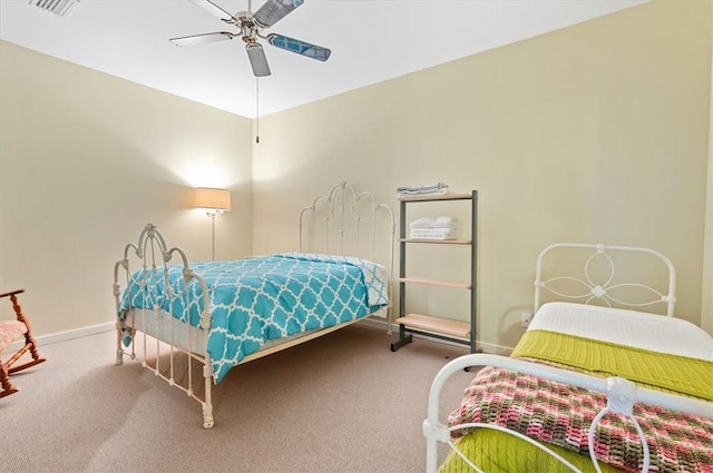 carpeted bedroom featuring baseboards and a ceiling fan