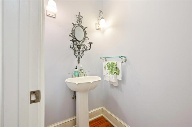 bathroom with baseboards and wood finished floors