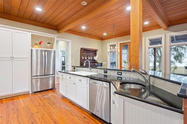 kitchen featuring beam ceiling, open shelves, appliances with stainless steel finishes, and a sink