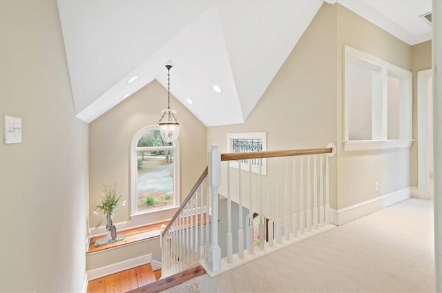 corridor with recessed lighting, baseboards, an upstairs landing, and vaulted ceiling