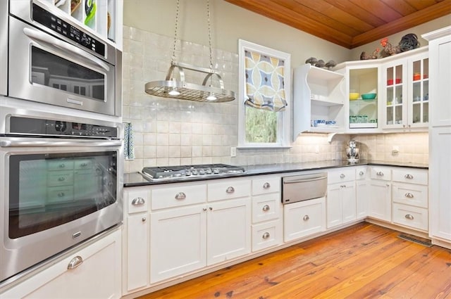 kitchen featuring tasteful backsplash, wood ceiling, a warming drawer, and stainless steel gas stovetop