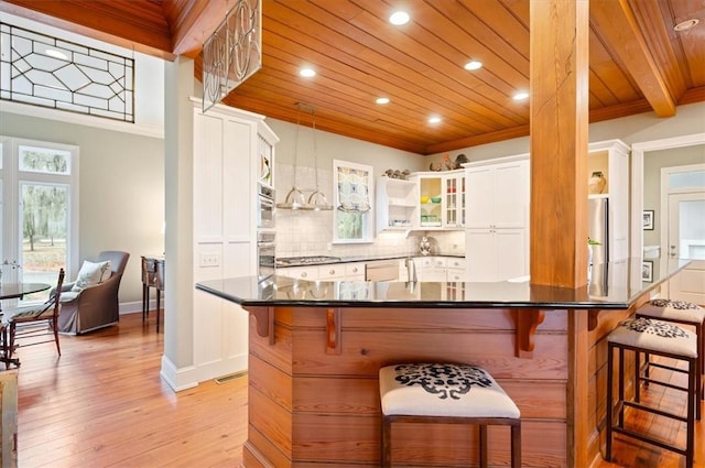 kitchen with decorative backsplash, wooden ceiling, crown molding, and appliances with stainless steel finishes