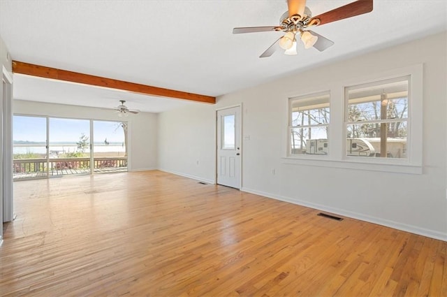 unfurnished living room featuring baseboards, light wood-style floors, visible vents, and ceiling fan