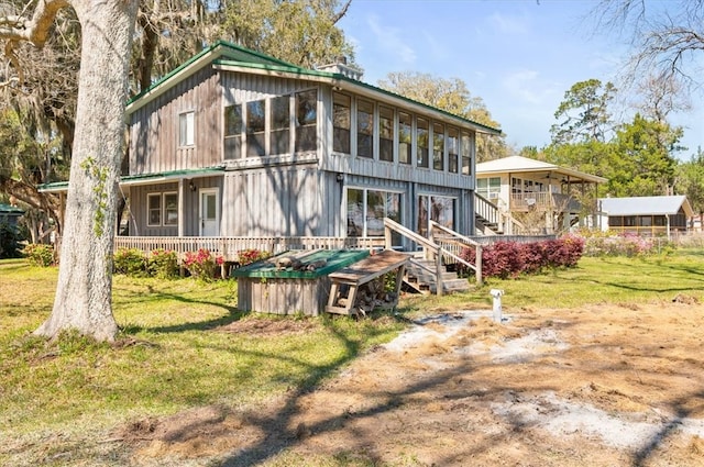 back of property with a lawn