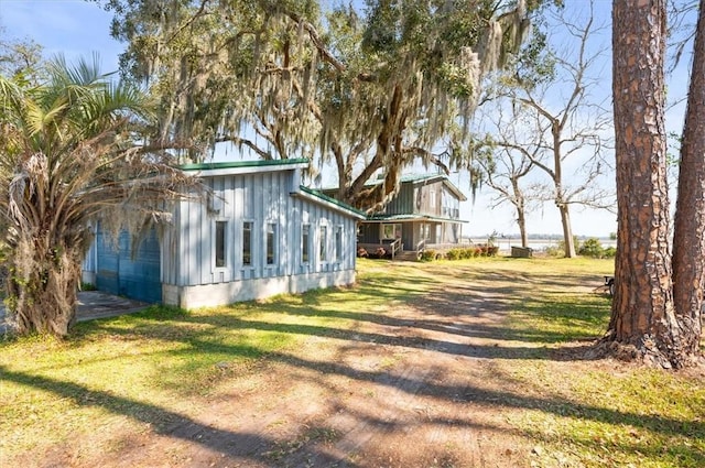 view of side of home with a lawn and board and batten siding