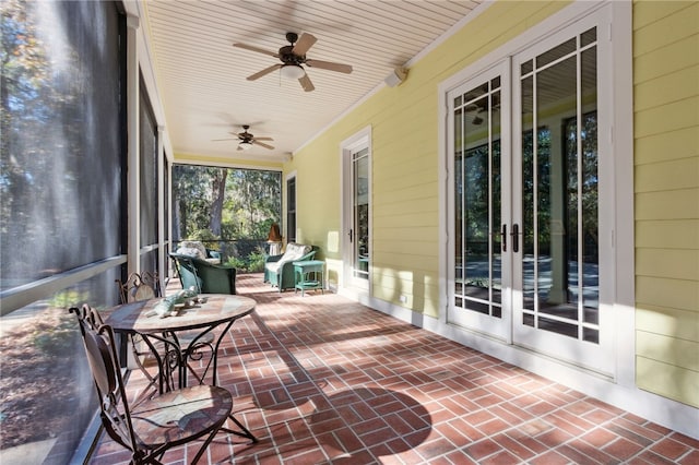 sunroom / solarium featuring ceiling fan