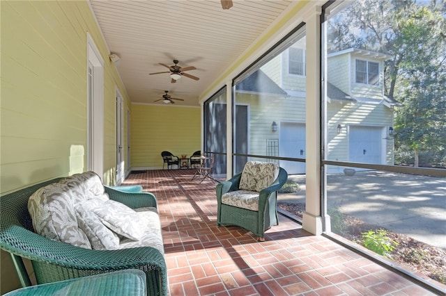 sunroom featuring ceiling fan and plenty of natural light