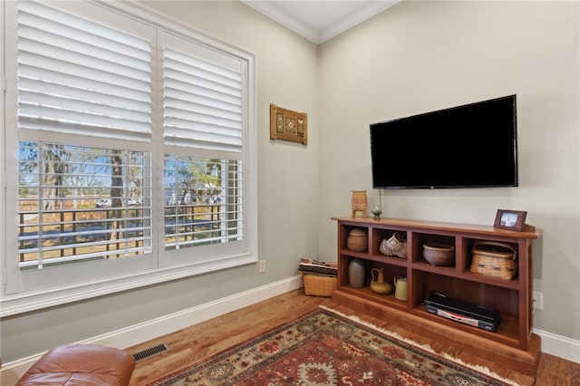 living room with hardwood / wood-style flooring and ornamental molding