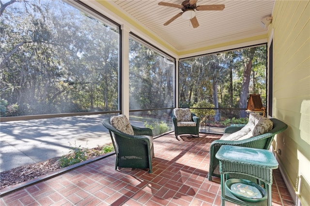 sunroom featuring ceiling fan