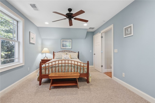 carpeted bedroom with ceiling fan and vaulted ceiling