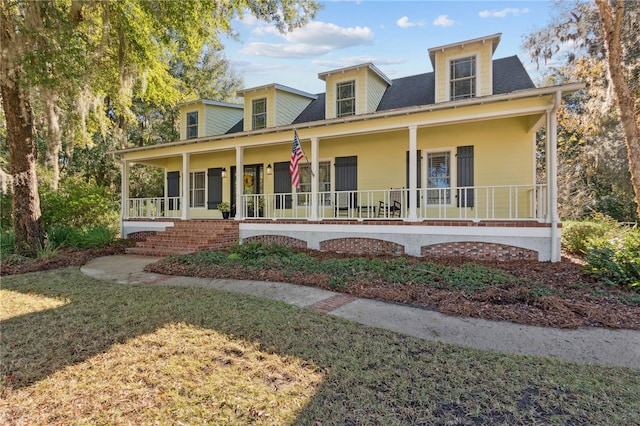 view of front of home with covered porch and a front yard