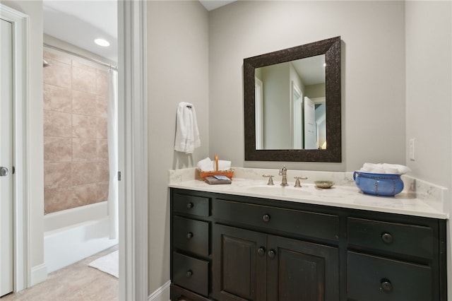 bathroom featuring vanity and tiled shower / bath combo