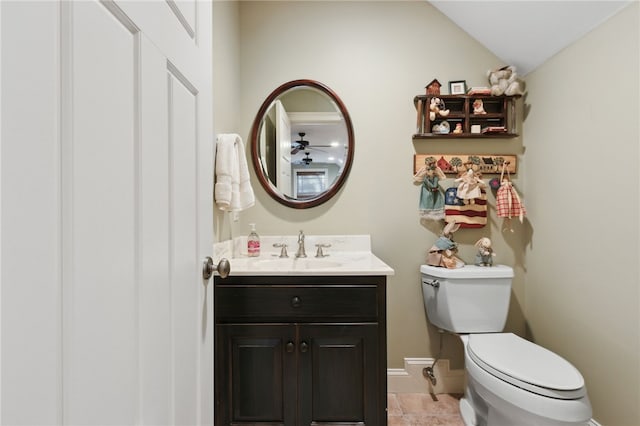 bathroom with vanity, ceiling fan, tile patterned flooring, toilet, and lofted ceiling