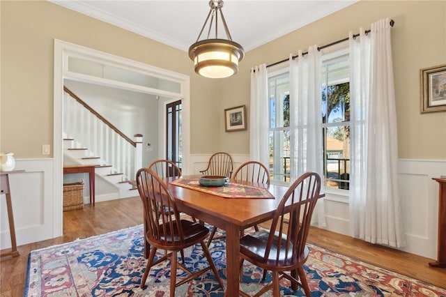 dining room featuring wood-type flooring and ornamental molding