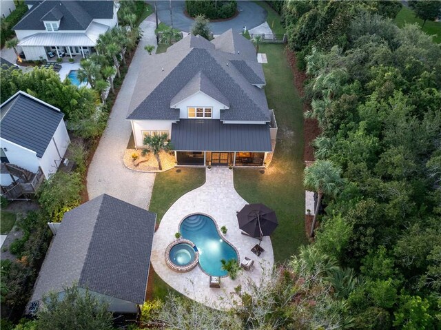 view of front of home with a garage, a lawn, and a porch