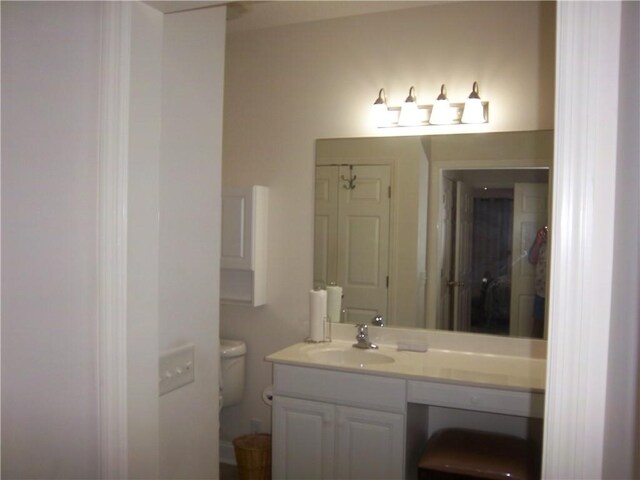 bathroom featuring vanity and toilet