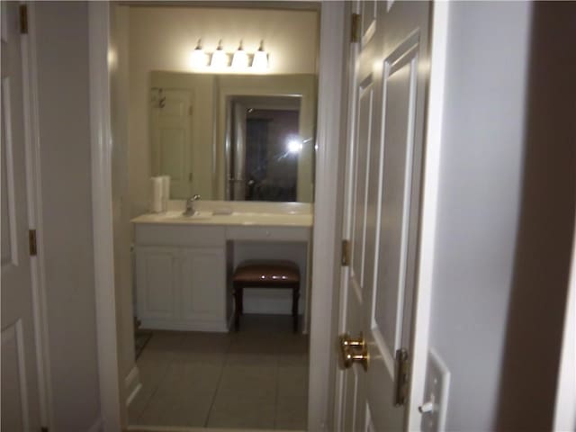 bathroom with tile patterned floors and vanity
