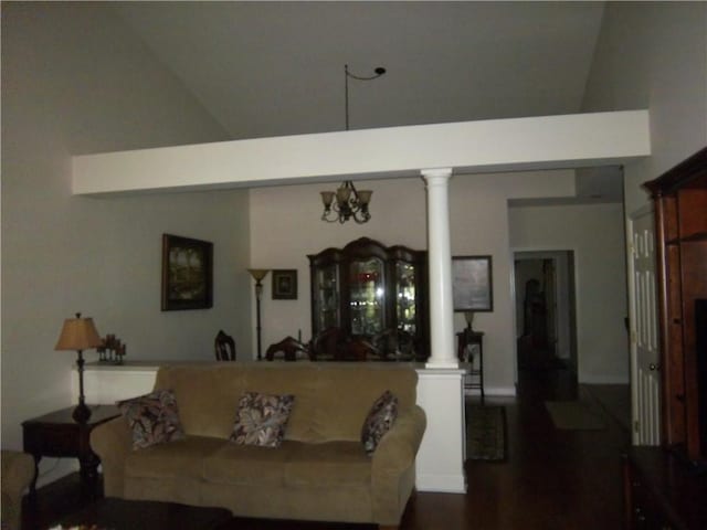 living area featuring ornate columns, high vaulted ceiling, and dark wood-type flooring