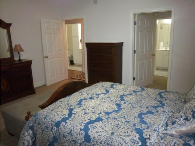 bedroom featuring carpet floors and connected bathroom