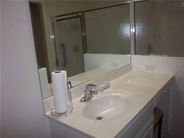 bathroom featuring a stall shower and vanity