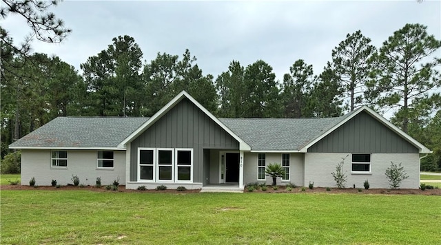 rear view of house featuring a yard