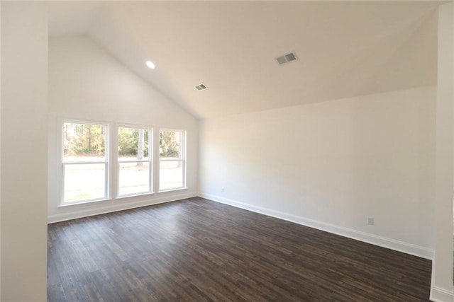 unfurnished room with dark hardwood / wood-style flooring and high vaulted ceiling