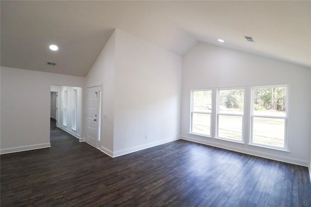 empty room with dark hardwood / wood-style floors and vaulted ceiling