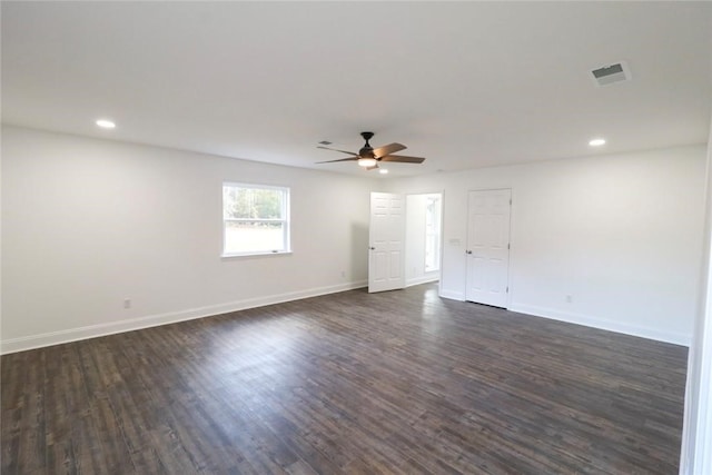 empty room with ceiling fan and dark wood-type flooring