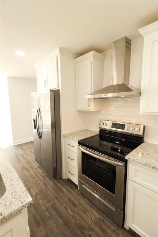 kitchen featuring white cabinets, dark hardwood / wood-style floors, wall chimney range hood, and appliances with stainless steel finishes