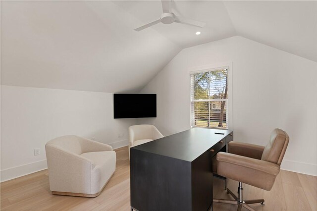 office space with baseboards, lofted ceiling, light wood-style floors, and ceiling fan