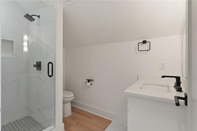 bathroom featuring a marble finish shower, baseboards, toilet, vaulted ceiling, and wood finished floors