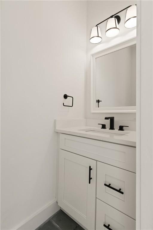 bathroom with vanity and baseboards