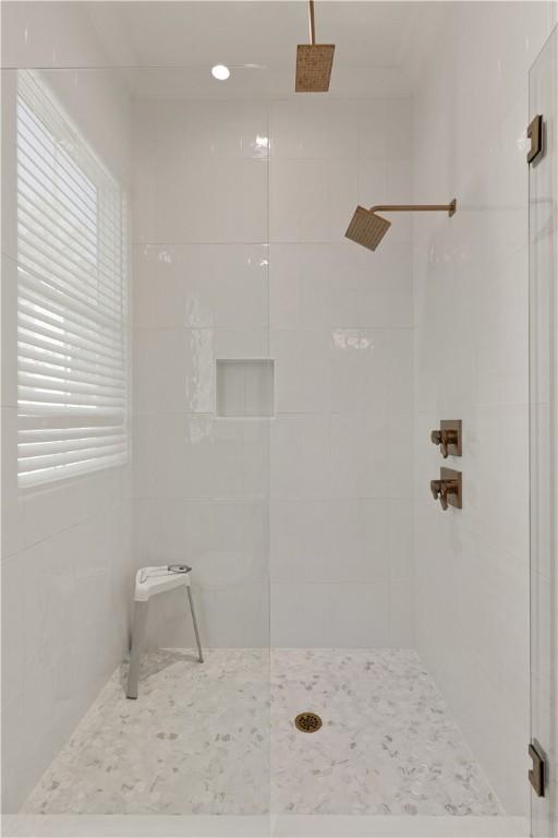 bathroom with a tile shower