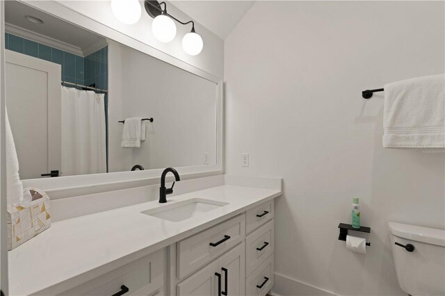 full bath with toilet, ornamental molding, curtained shower, baseboards, and vanity