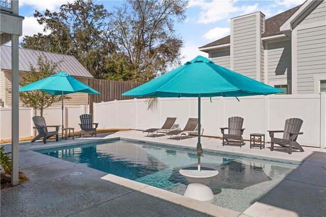 view of swimming pool with a fenced in pool, a patio, and a fenced backyard