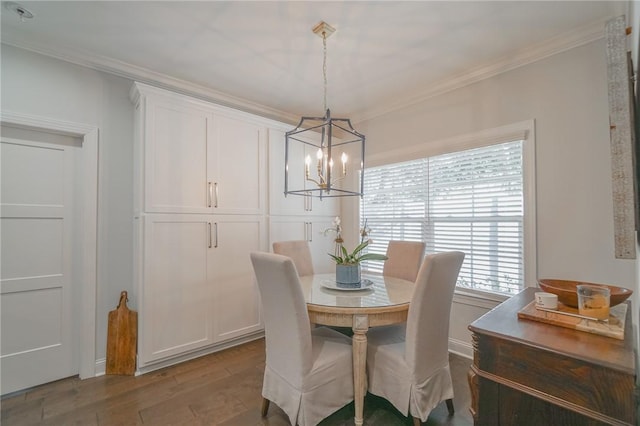 dining area featuring hardwood / wood-style floors, a notable chandelier, and ornamental molding