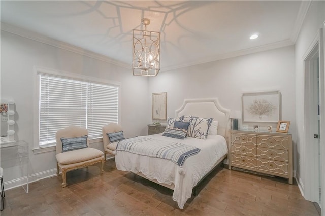 bedroom with hardwood / wood-style floors, a notable chandelier, and ornamental molding