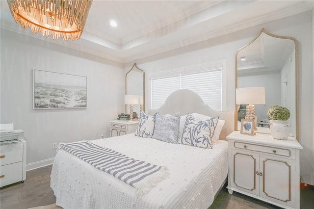 bedroom featuring a notable chandelier, a raised ceiling, dark wood-type flooring, and crown molding