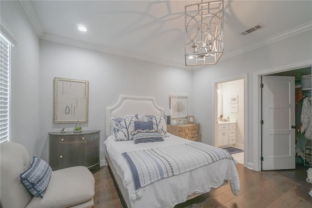 bedroom featuring connected bathroom, dark wood-type flooring, a notable chandelier, and ornamental molding