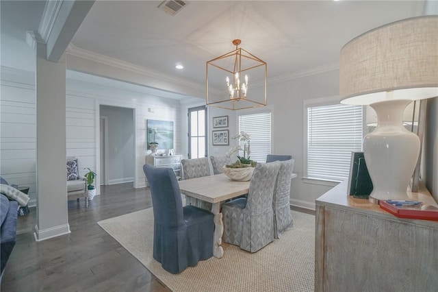 dining room with dark hardwood / wood-style flooring, a chandelier, and ornamental molding