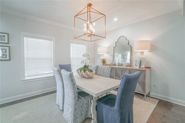 dining area featuring an inviting chandelier, dark hardwood / wood-style floors, and ornamental molding