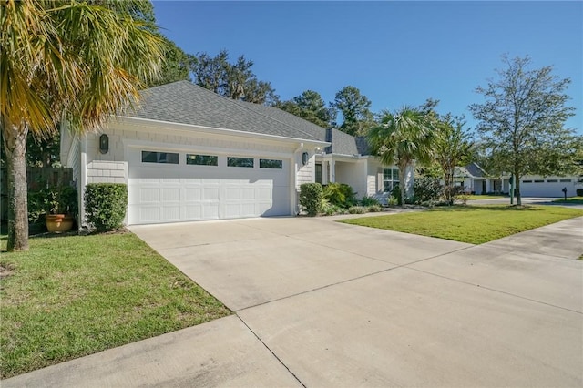 view of front of house featuring a garage and a front lawn