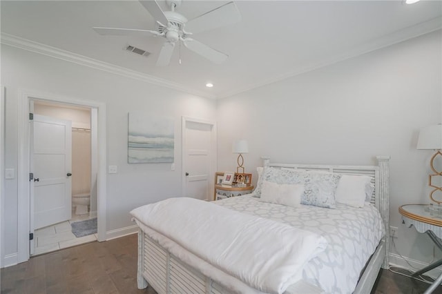 bedroom with ensuite bathroom, crown molding, ceiling fan, and dark wood-type flooring