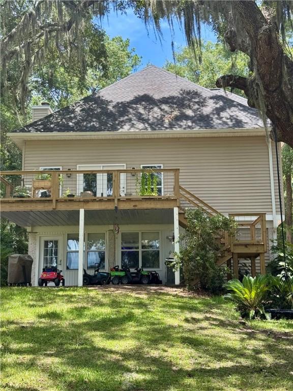 1356 Fiddler Trce NE, Townsend, GA 31331 - rear view of property with a lawn, a deck, stairs, and a chimney